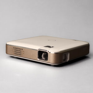 Gold and white Kodak Luma 150 portable projector, viewed from the front and side.